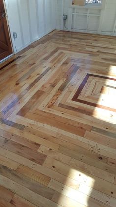 an empty room with wooden floors and white walls