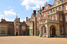 an old brick building with a clock tower in the middle of it's courtyard