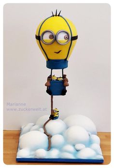 a yellow and blue toy with glasses on it's head is surrounded by white balls