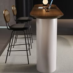 a table with two stools next to it and a clock on the wall behind it