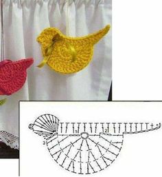 two crocheted birds hanging from curtains