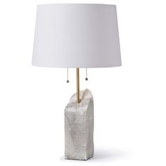 a table lamp with a white shade on the base and a gold - plated metal rod