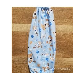 a blue dog print diaper cover on a wooden floor