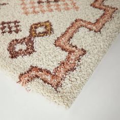 a white rug with brown and tan designs on it