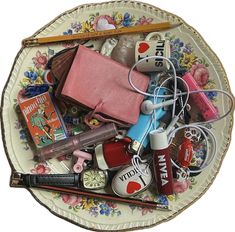 a plate with various items on it including lipstick, eyeliners and makeup brushes