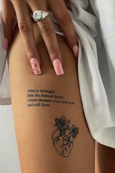 a woman's leg with a tattoo saying what is stronger than the human heart