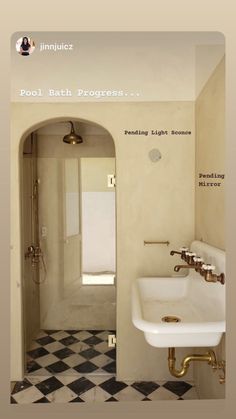 a bathroom with black and white checkered flooring, gold faucet, and sink