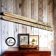 a couple of wooden skis sitting on top of a table next to framed pictures