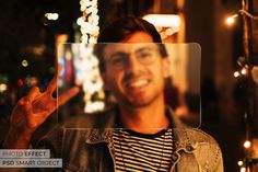 a man is smiling and making a peace sign in front of the camera with his hand