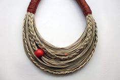 a necklace with red beads is shown on a white surface