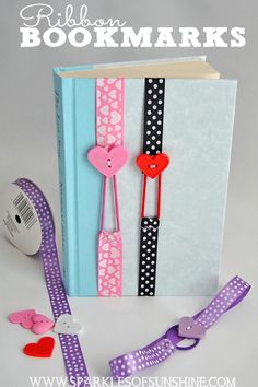 the bookmarks are made out of paper and ribbon, with hearts on each side