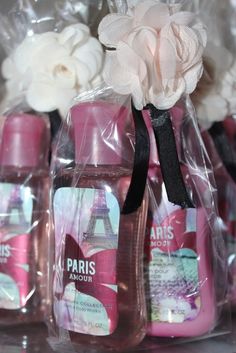 paris shower products are wrapped in plastic and placed on a shelf next to white flowers