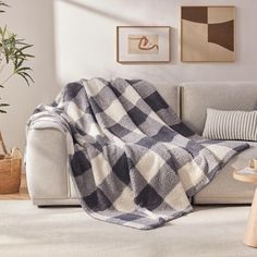 a couch with a blanket on it in a living room