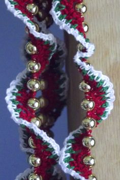 a close up of a pair of bracelets with bells on it's sides