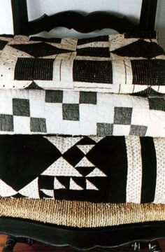 a black and white quilt on top of a bed