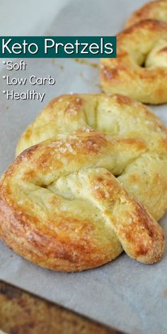 two freshly baked keto pretzels on a baking sheet