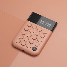 a pink calculator sitting on top of a pink surface