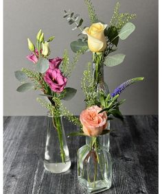 three vases filled with different types of flowers