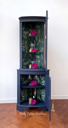 a blue cabinet with flowers and candles on it