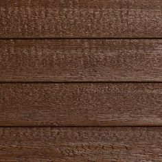 closeup of the wood grains on a wooden wall textured with dark brown stain