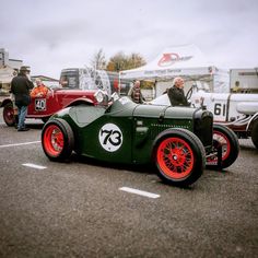 an antique car is parked in a parking lot