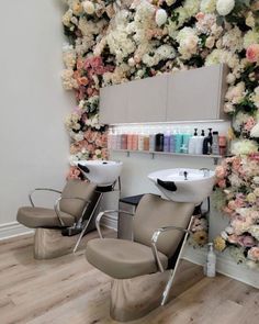 a salon with chairs and flowers on the wall