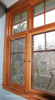 an open window with some string hanging from it