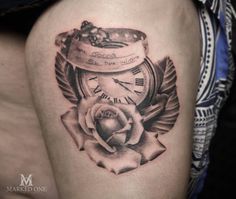 a tattoo with a clock and rose on it