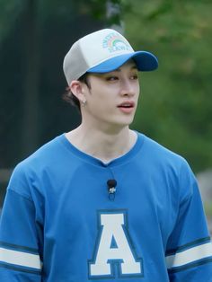 a young man wearing a blue and white baseball uniform with the letter a on it