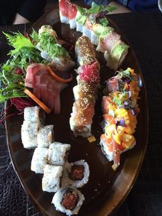 sushi platter with various types of meats and veggies on it