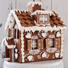 a gingerbread house made to look like it has been decorated with white and brown icing