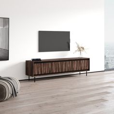 an empty living room with a large tv on the wall