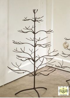 a metal tree is standing in front of a door