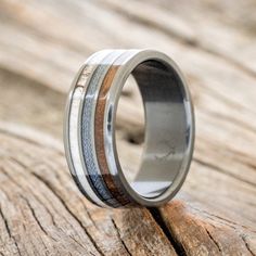 a wedding ring with wood and silver inlays