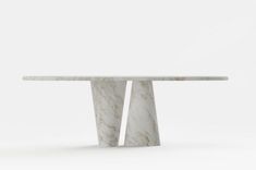 a white marble table with two curved legs