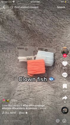 an orange and white cord on top of a gray fur covered surface with text that reads clown fish