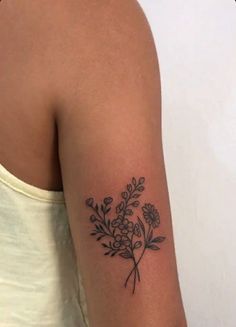 a woman with a flower tattoo on her arm