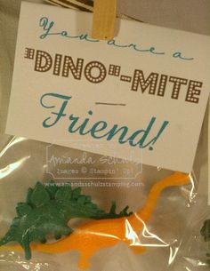 there is a sign that says dino - mite friend with an orange dinosaur on it