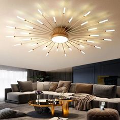 a living room filled with furniture and a round light fixture hanging from the ceiling above it