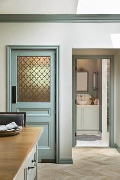 an open door leading to a bathroom with a sink