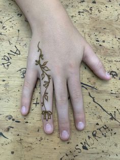 a person's hand with a tattoo on it