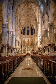 the inside of a large cathedral with pews