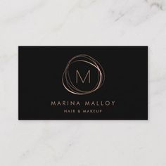 a black and gold business card with the letter m on it's front side