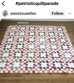 a red, white and blue quilt is on the floor