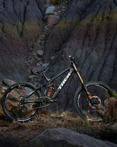 a mountain bike parked on the side of a rocky hill