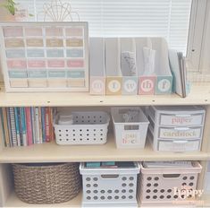 a book shelf filled with lots of books and baskets