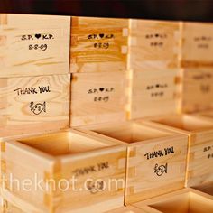 many wooden boxes are stacked on top of each other with thank you written on them