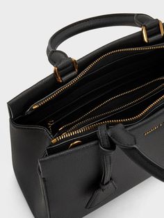 This product is made with at least 20% sustainable materials by weight. CHARLES & KEITH uses recycled, degradable, organic, and water-based materials in our eco-conscious collection. A polished carry-all is a wardrobe essential for the modern woman on the go, and the sleek Mirabelle structured top handle bag fits the bill. Its minimal black exterior exudes sophistication, complete with a gold-accent bag charm for visual interest. The secure zip closure opens up to a roomy interior that will fit everything you need and more. You can easily tote it by the sturdy top handles, or clip on the adjustable strap to sling it on the shoulder. Black Purse Gold Hardware, Luxury Top Handle Shoulder Bag With Gunmetal Hardware, Structured Bags For Women, Black Satchel Bag, Dark Academia Outfit, Belt Ring, Structured Top, Structured Bag, Black Satchel