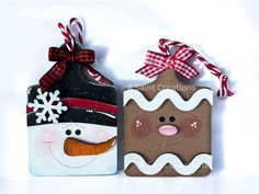 two christmas gift bags with snowman and gingerbread cookies on them