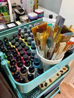 an organized drawer with lots of paint and brushes